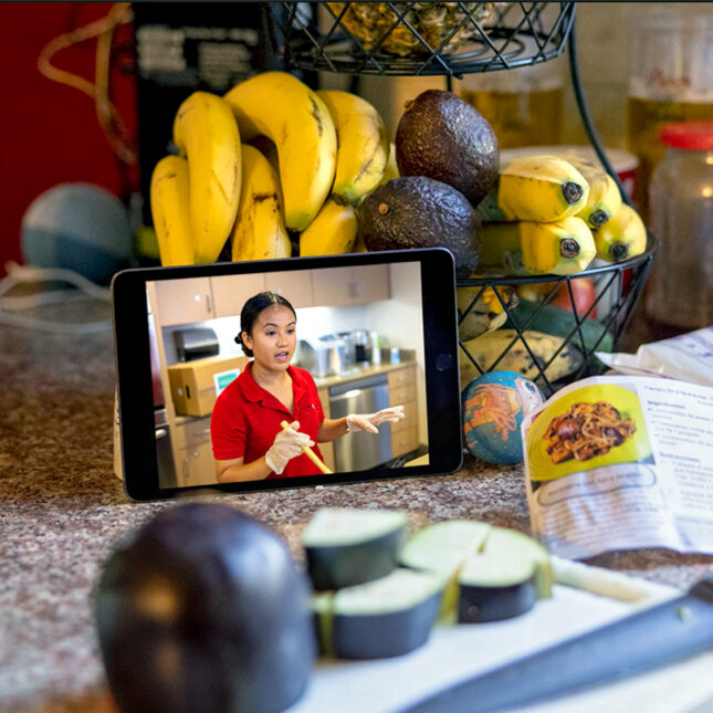 An ipad on a kitchen counter surrounded by fruit and veggies. -- health coverage from STAT