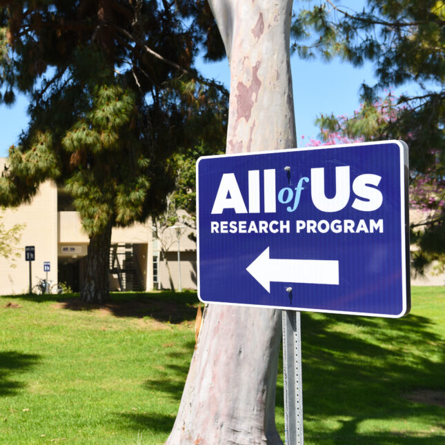 All of Us Research Program blue sign with a left-pointing arrow — first opinion coverage from STAT