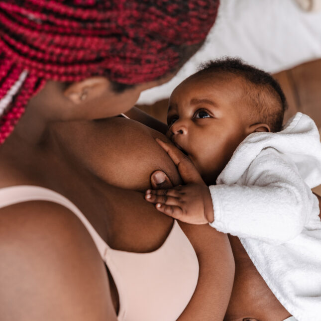 Photo of a mom breastfeeding her baby. -- health coverage from STAT
