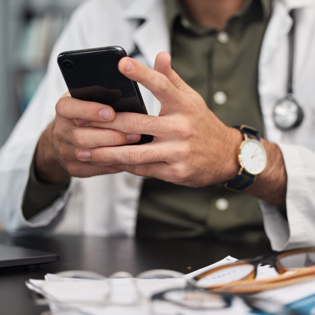 Photo of a doctor holding a cellphone. -- first opinion coverage from STAT