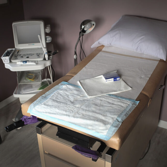 A photograph of an exam room in a women's health center, which provides abortions – abortion and reproductive health coverage from STAT