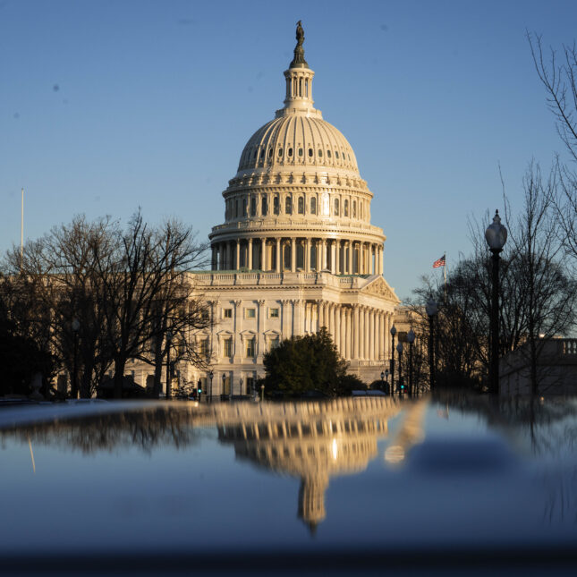 exterior of U.S. Capitol with blue sky and a reflection of the scene underneath – health tech coverage from STAT