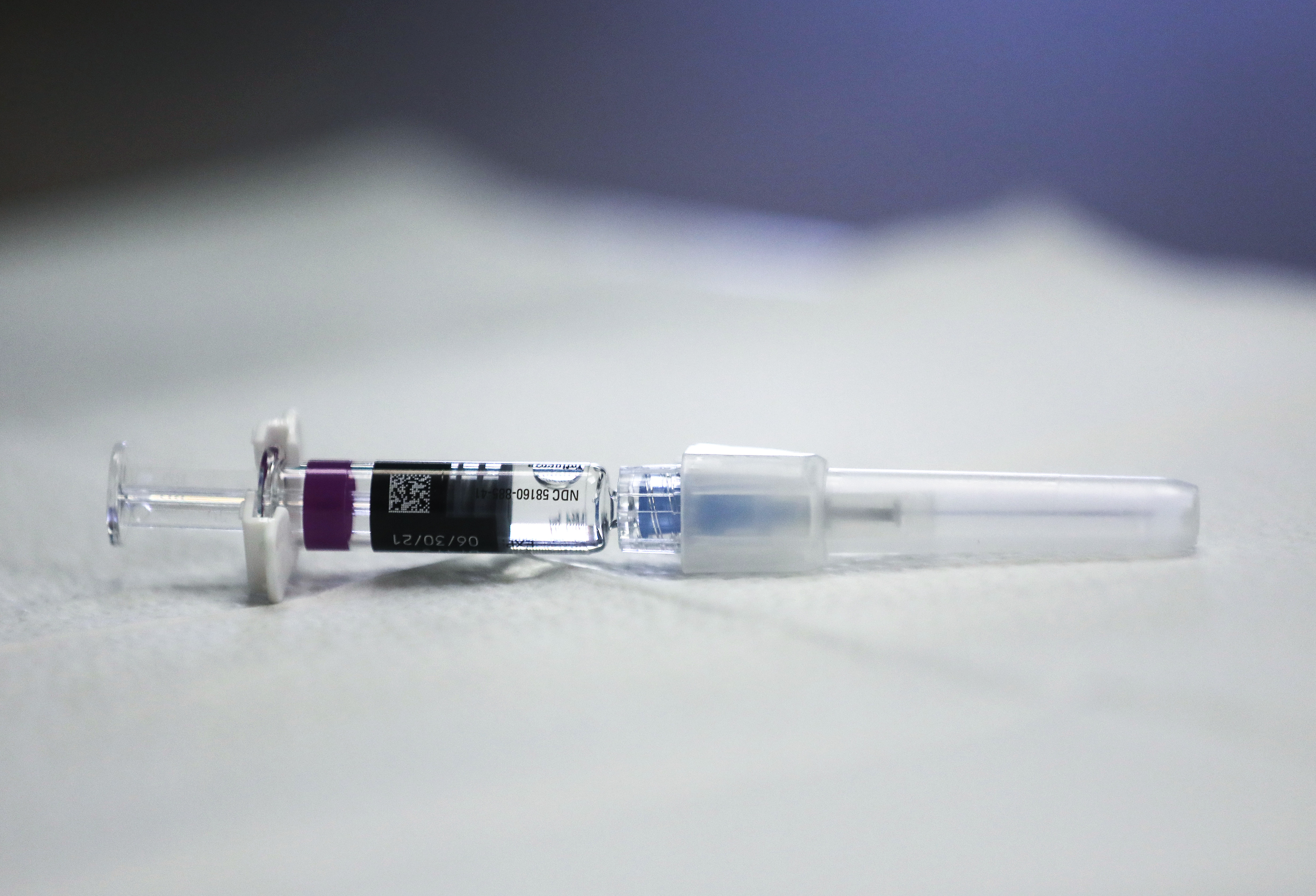 A flu vaccine syringe rests on a table at a free flu vaccination clinic
