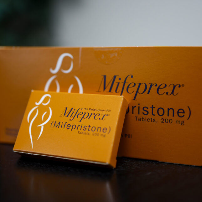 A single package of Mifepristone leans back against a Mifepristone box — coverage from STAT