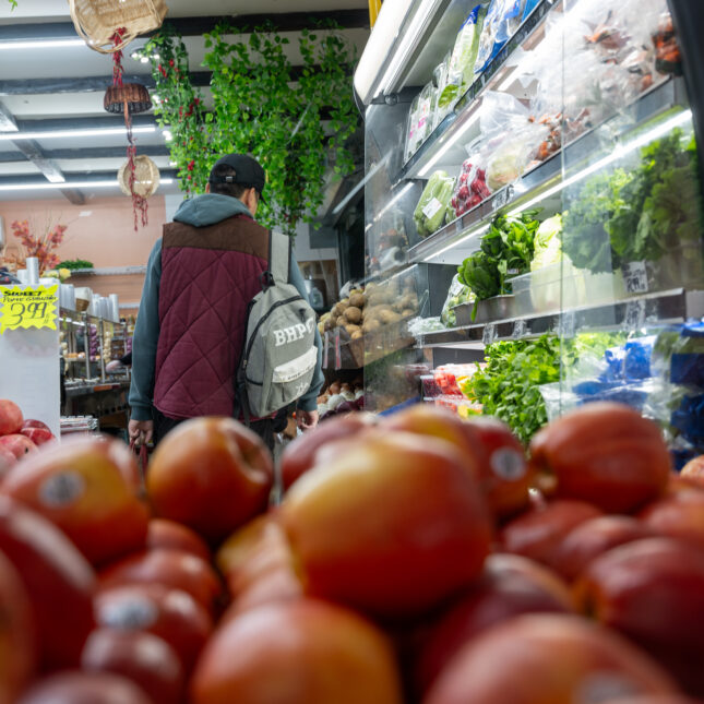 Two customers look through options in the food aisle — coverage from STAT