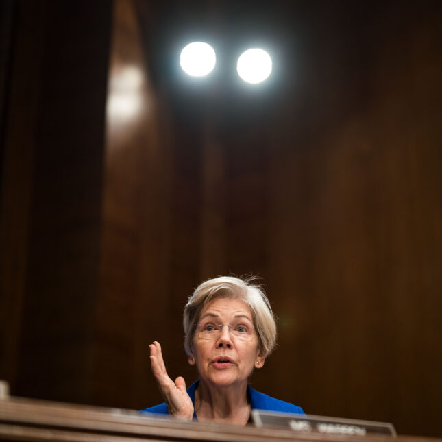 Sen. Elizabeth Warren gestures with one hand during a hearing — insurance coverage from STAT