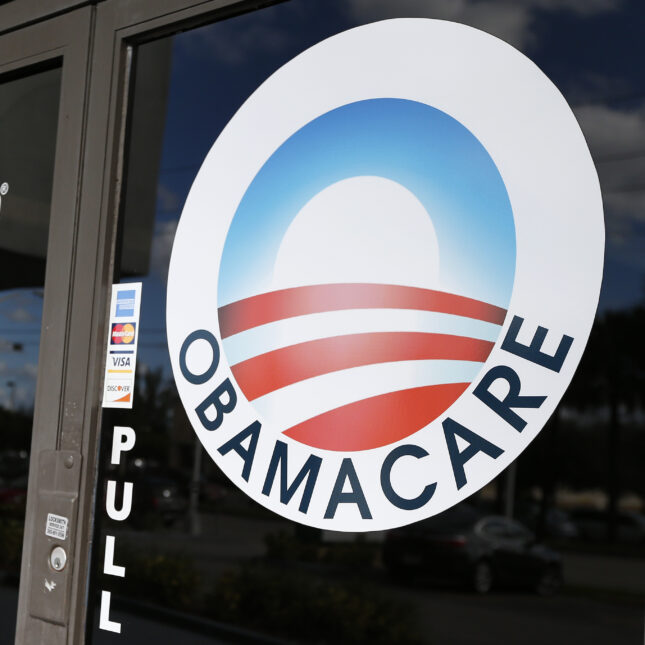 A logo of Obamacare on the glass door of UniVista Insurance agency — politics coverage from STAT