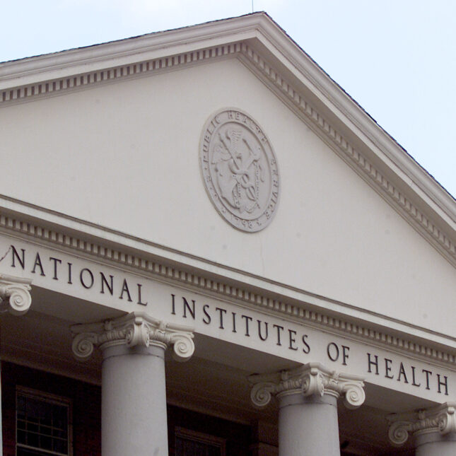 a building embellished with the words "National Institutes of Health" — health coverage from STAT