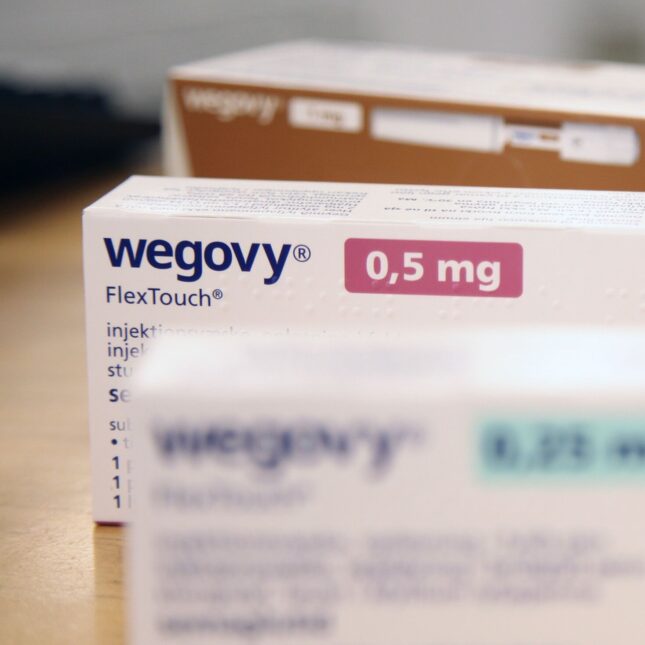 Three boxes of Wegovy stands in a line — coverage from STAT